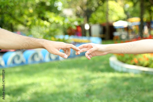 Two hands over green nature park