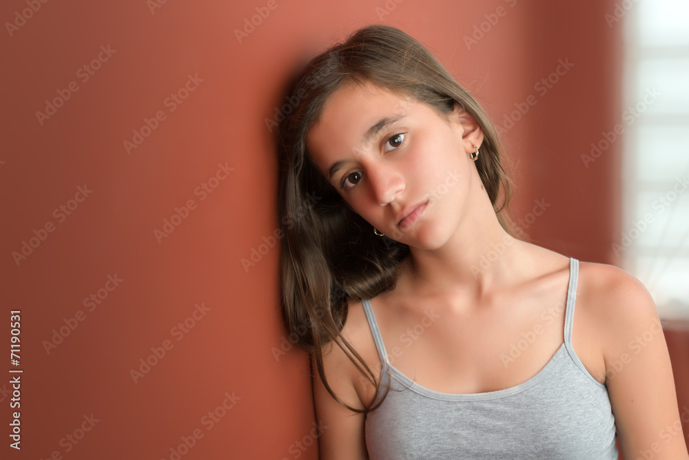 Hispanic teenage girl with a serious expression Hispanic teenage girl with a serious expression
