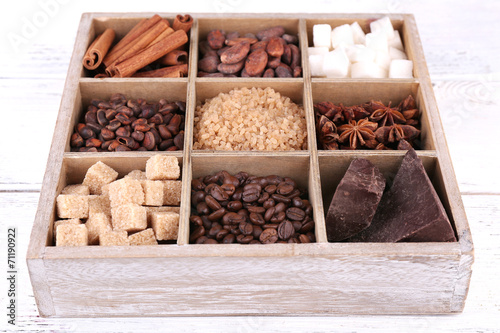 Wooden box with set of coffee and cocoa beans, sugar cubes,