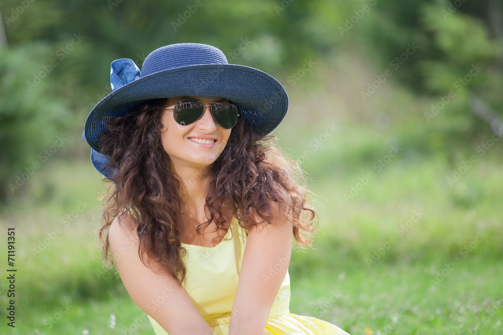 Portrait of a young smiling woman in the park