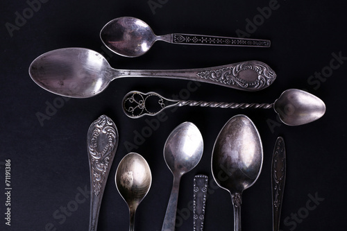 Metal spoons on black background © Africa Studio