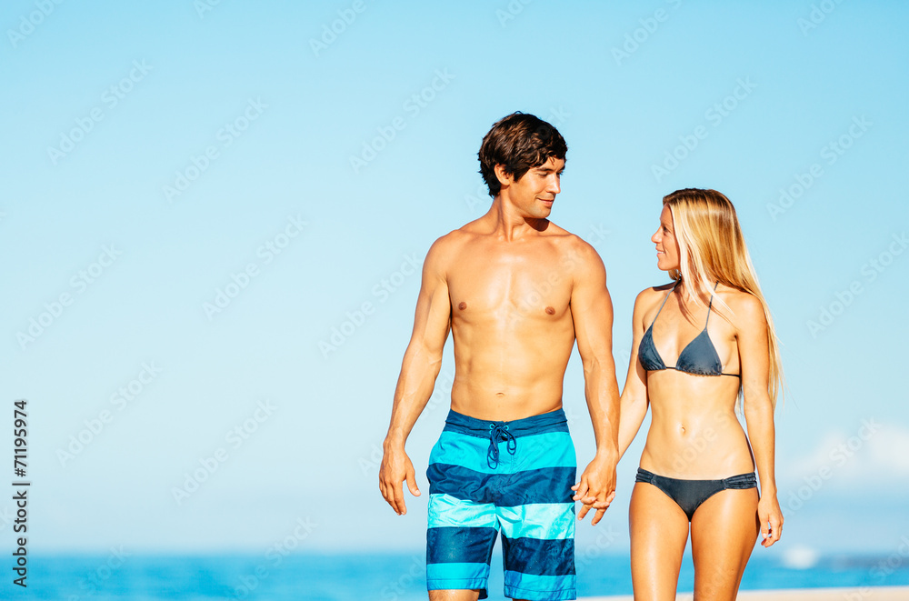 Attractive Couple Walking on Tropical Beach Attractive Couple Walking on Tropical Beach