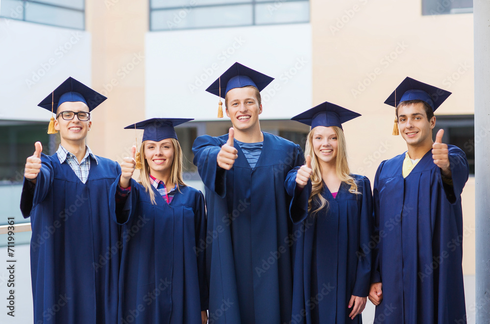 group of smiling students in mortarboards group of smiling students in mortarboards
