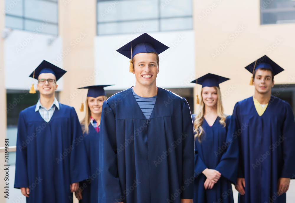 group of smiling students in mortarboards group of smiling students in mortarboards