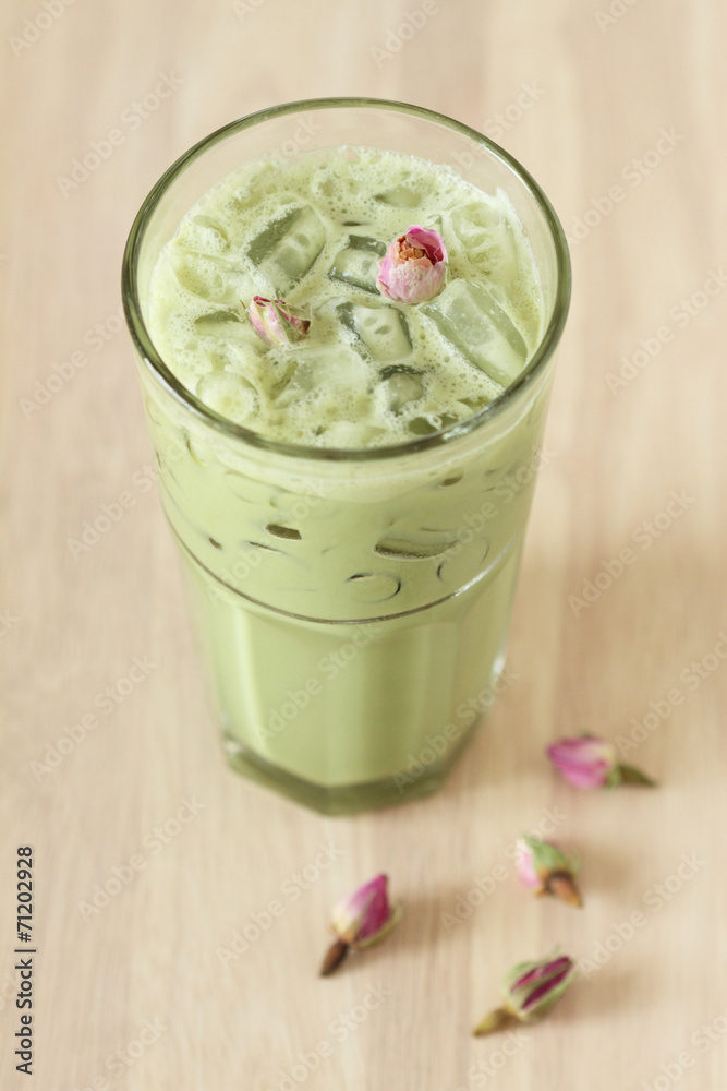glass of green tea latte decorated with dried rose glass of green tea latte decorated with dried rose