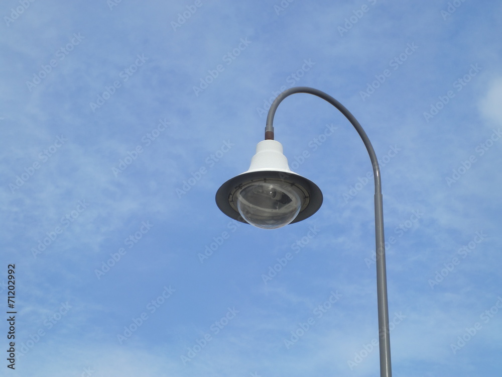 a street light pole with a blue sky background a street light pole with a blue sky background
