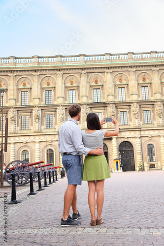 Tourists taking photo of Stockholm Royal Palace