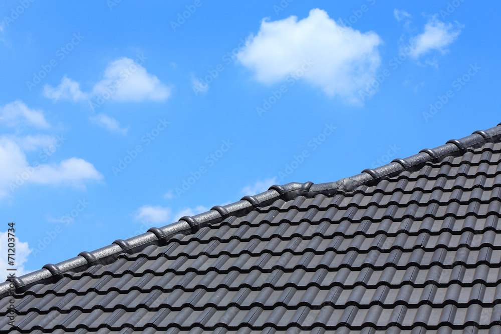 tile roof on a new house with blue sky tile roof on a new house with blue sky