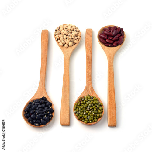 Green beans, black beans, red beans in wooden spoon, white backg