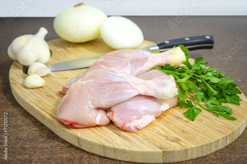 Raw chicken legs on cutting board