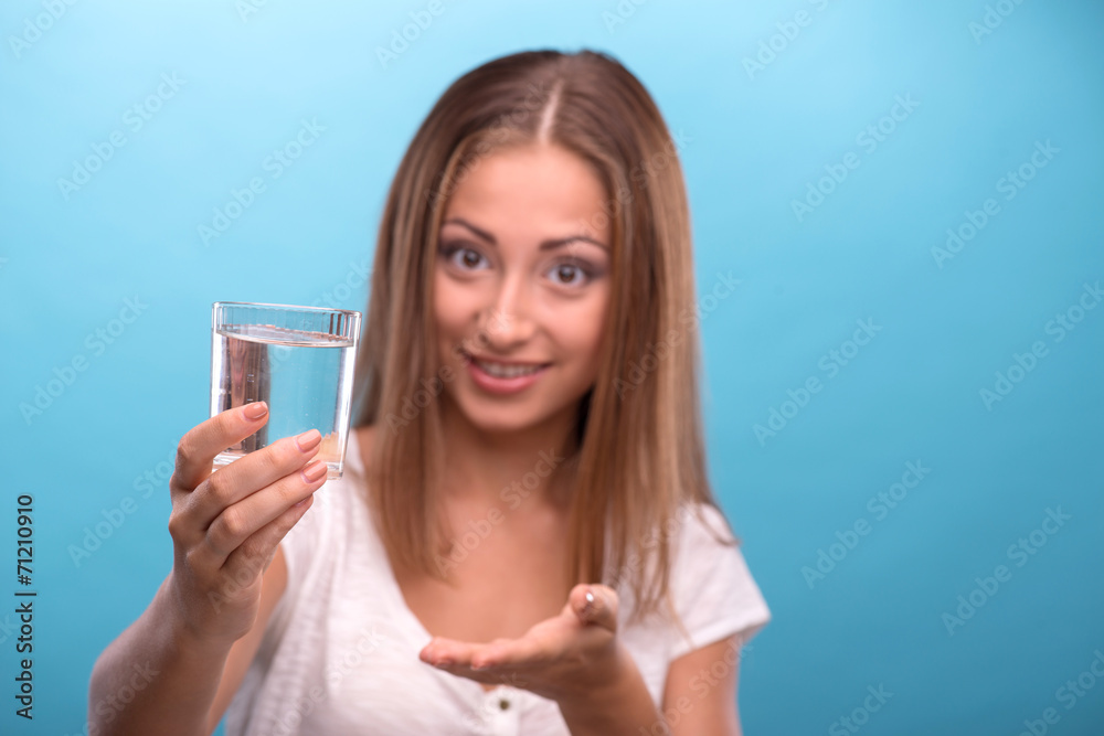 Portrait of young beautiful girl holding a glass with clean wate Portrait of young beautiful girl holding a glass with clean wate