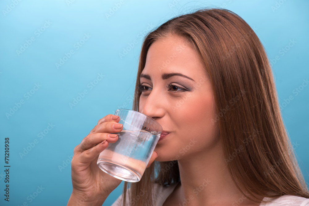 Portrait of young beautiful girl drinking clean water from a gla Portrait of young beautiful girl drinking clean water from a gla