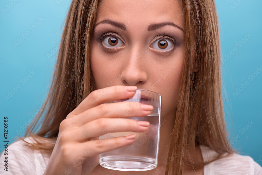 Portrait of young beautiful girl drinking clean water from a gla Portrait of young beautiful girl drinking clean water from a gla