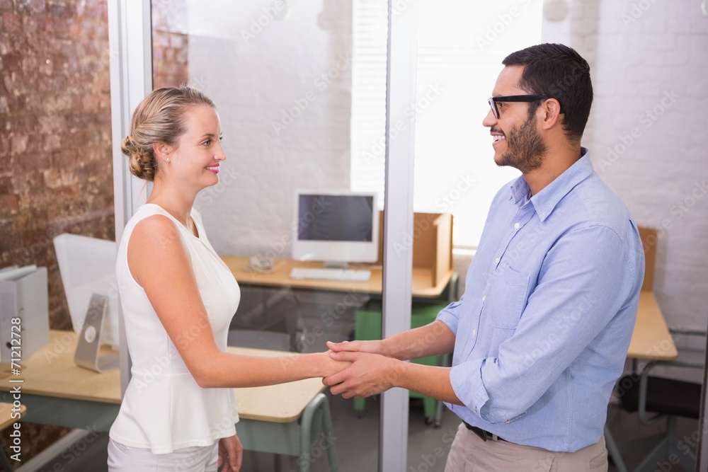 Executives shaking hands in office Executives shaking hands in office