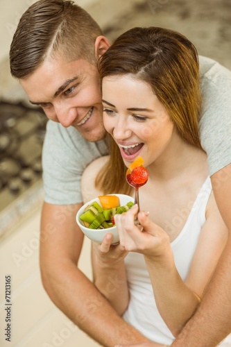 Couple eating fruit salad at breakfast