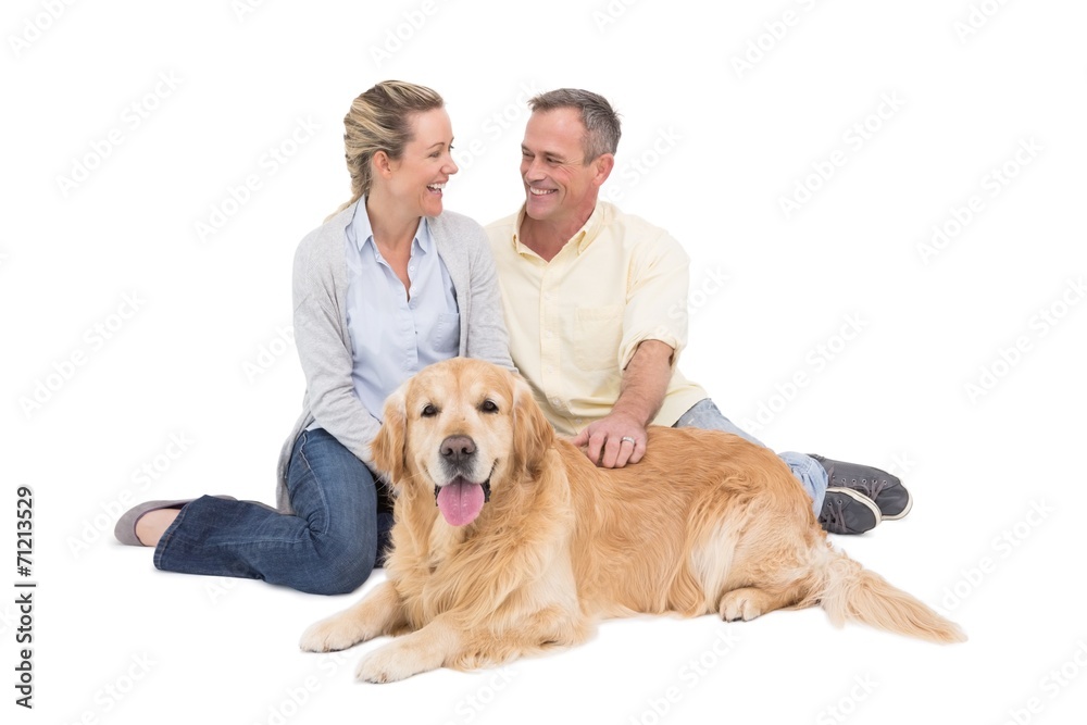Portrait of smiling couple sitting together with their dog Portrait of smiling couple sitting together with their dog