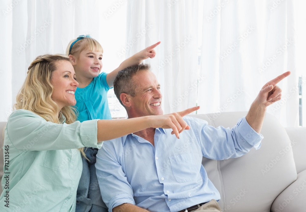 Obraz premium Nice parents and daughter pointing something