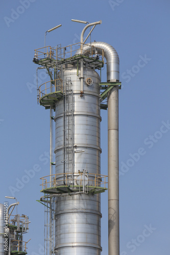 Vertical refining tower with blue sky