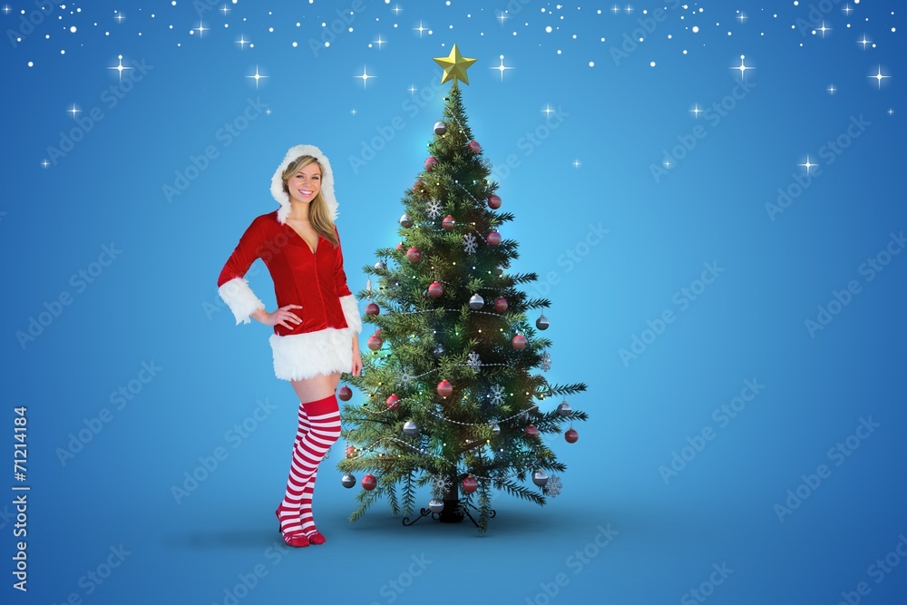 Composite image of pretty girl smiling in santa outfit Composite image of pretty girl smiling in santa outfit