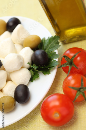 Mozzarella, olives, cherry tomatoes and olive oil.