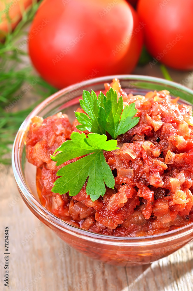 Tomato sauce in glass bowl, close up view