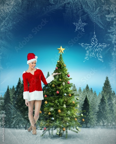 Composite image of pretty santa girl presenting with hand