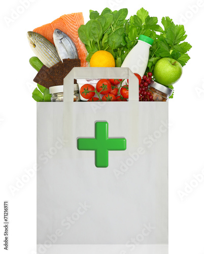 Paper bag with medical green cross filled with healthy foods #71216971
