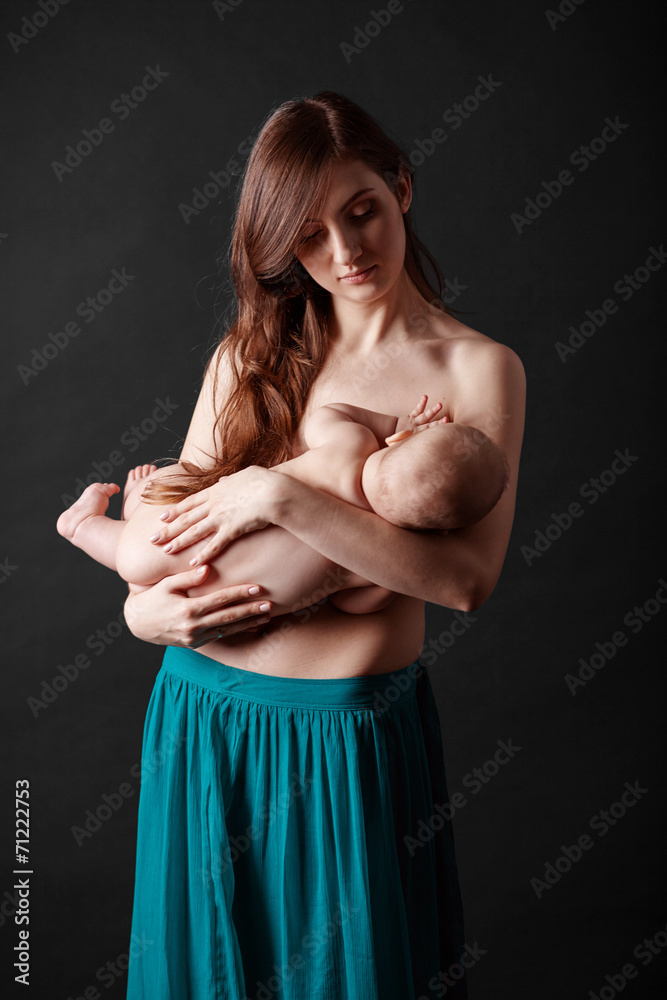Fototapeta premium Mother breast feeding her infant