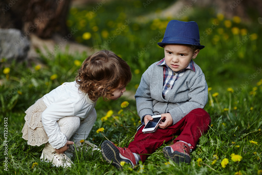 boy and girl playing with mobile phone boy and girl playing with mobile phone