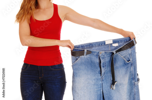 Fotografie Woman holding big pants.
