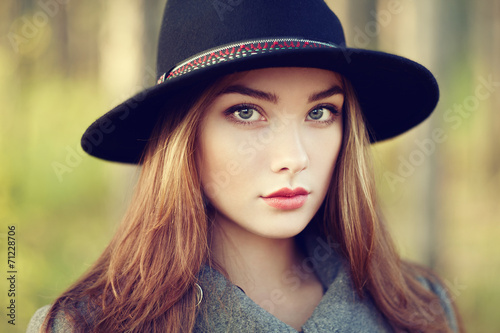 Portrait of young beautiful woman in autumn coat