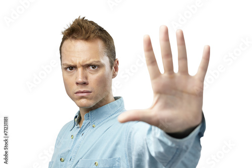 Young man giving hand stop sign
