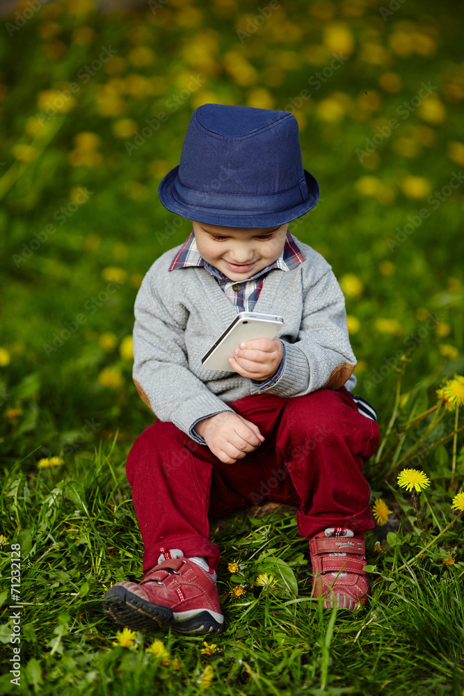 little modern boy with mobile phone little modern boy with mobile phone