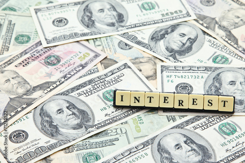 Word interest on pile of US dollar banknotes © viewcapture