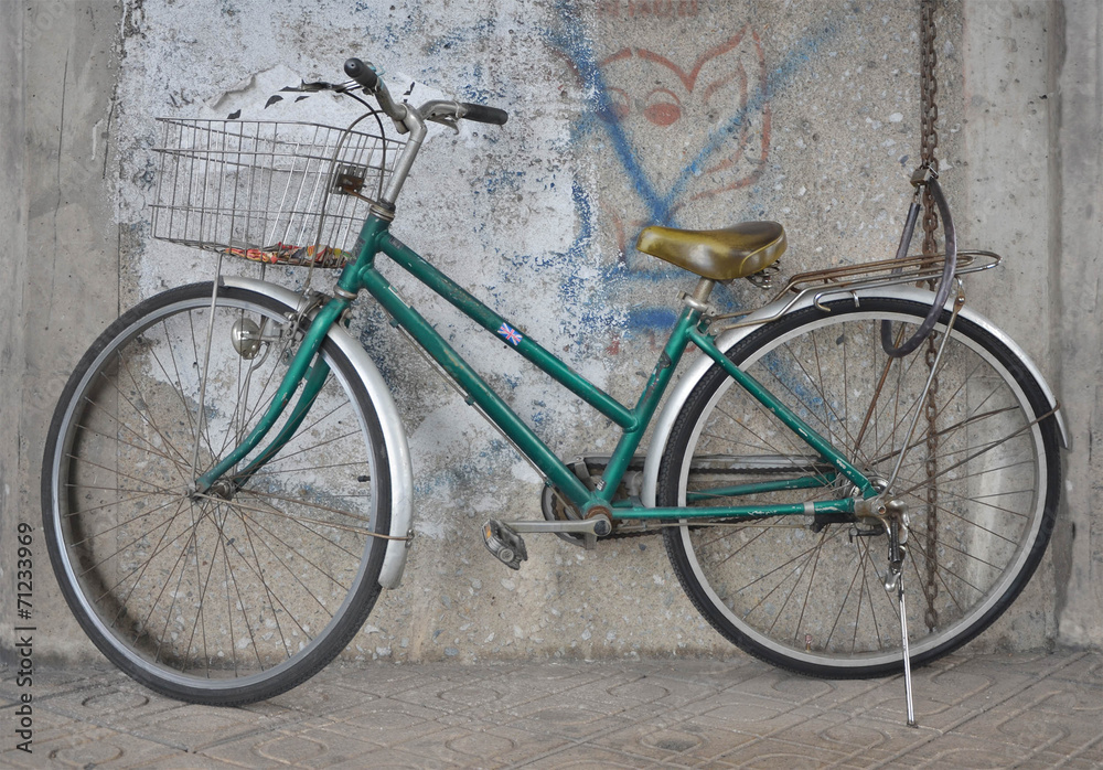green old bicycle and the wall