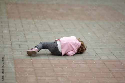 alone crying girl lying on asphalt