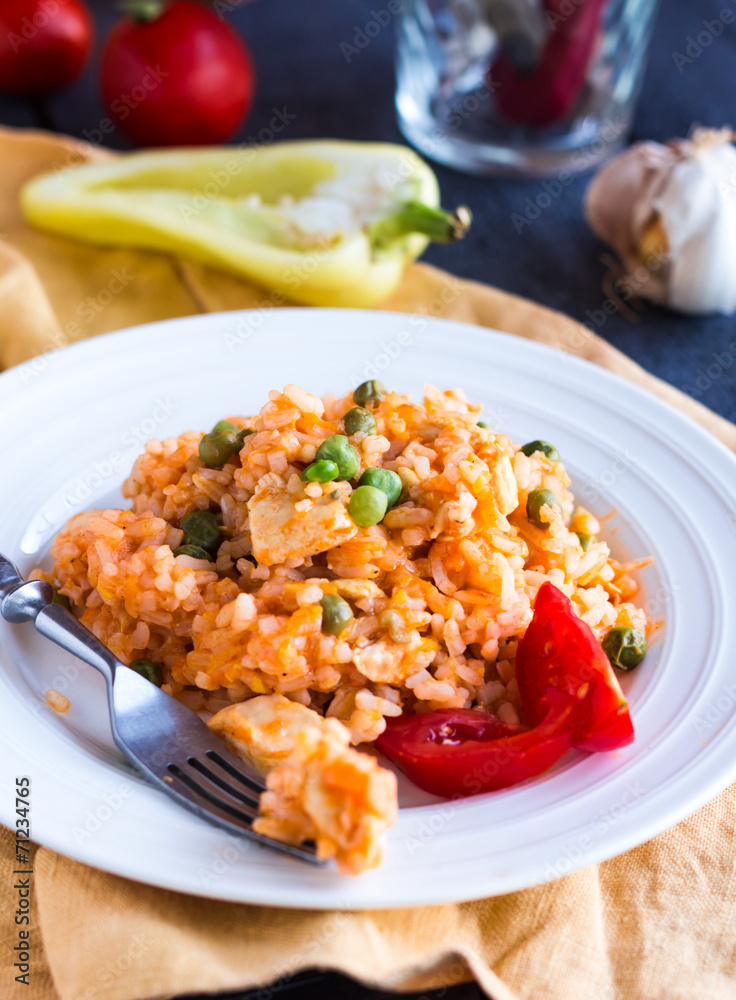 risotto with chicken and vegetables on a plate with fork