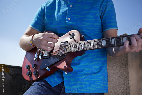 Playing electric guitar