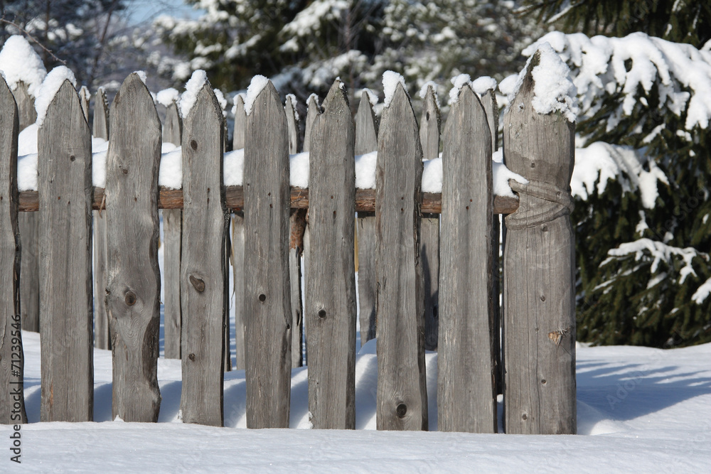 Wooden fence in the forest Russian village,