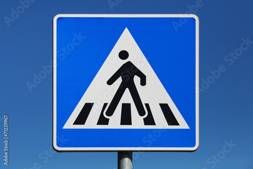 Pedestrian crossing. Road sign above blue sky background