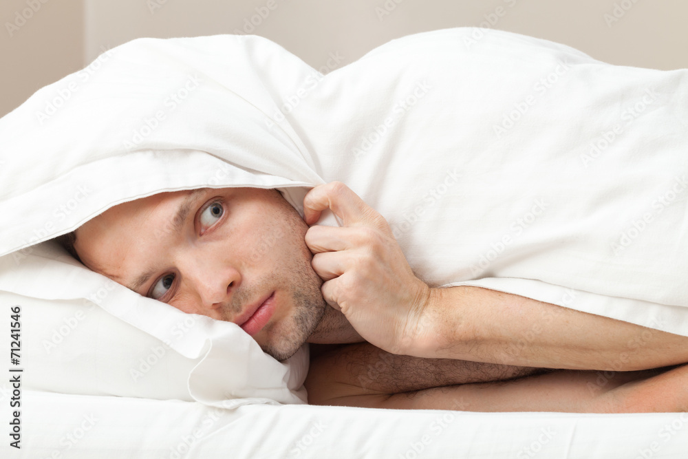 Portrait of funny scared Young Caucasian man in bed Portrait of funny scared Young Caucasian man in bed