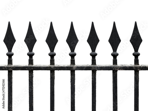 Old cast iron fence with spears isolated on white. Seamless frag