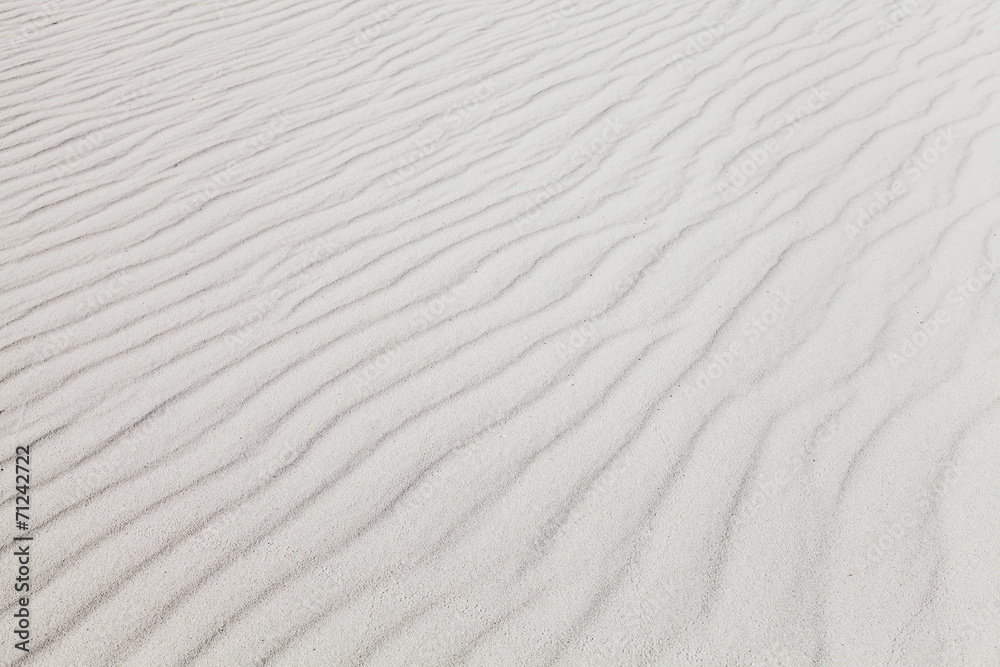 White sand with wave pattern. Background photo texture