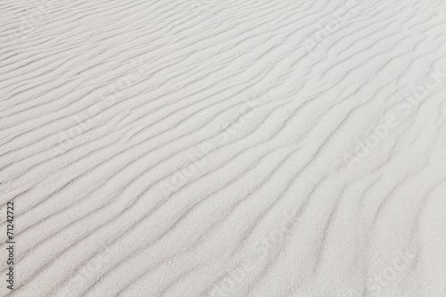 White sand with wave pattern. Background photo texture