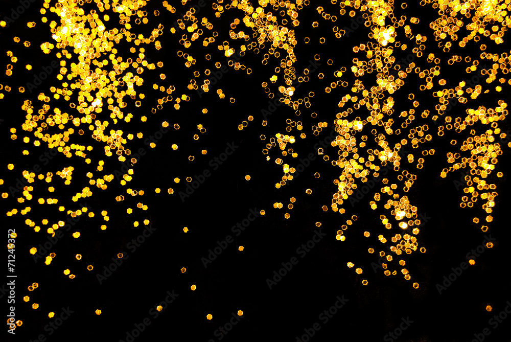 golden glitter sparkle on black background golden glitter sparkle on black background