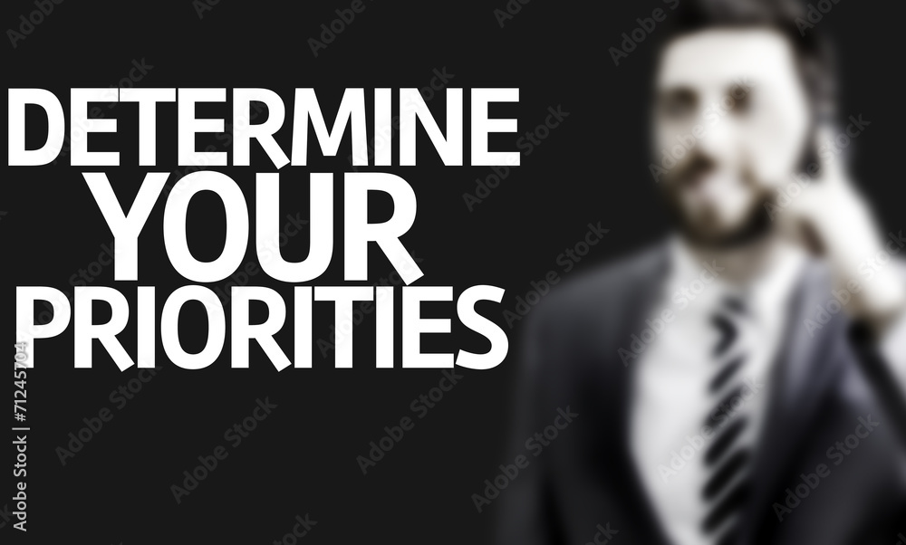 Business man with the text Determine your Priorities Business man with the text Determine your Priorities