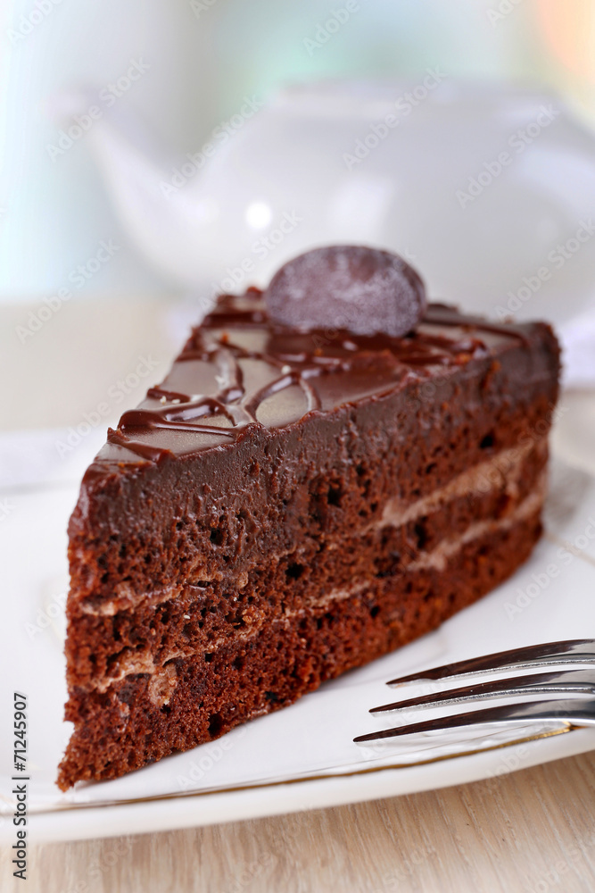 Piece of chocolate cake on plate on light background Piece of chocolate cake on plate on light background