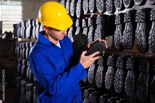 quality controller checking rubber-boots sole photo