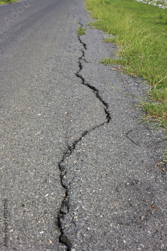 road asphalt damage crack grass green growing