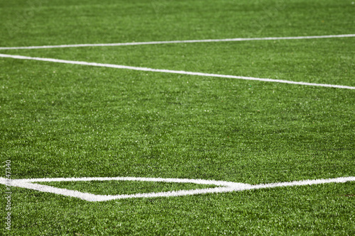 Football playing field background with white marking on green gr